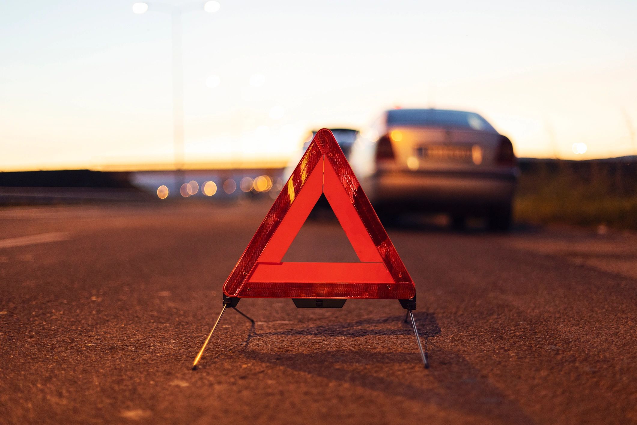 Vehicle with breakdown warning triangle on the road
